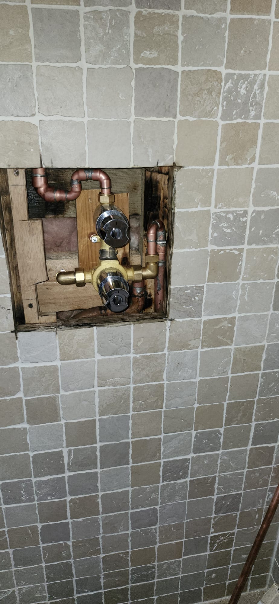 Old shower valve exposed in tiled wall before replacement in Marden